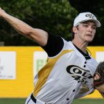 Pitcher, Noah Madsen, delivers to the plate.