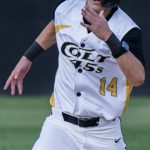 Base runner, Trajan Rogowski, heads for third base.