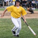 Colt 45s batgirl returning to the dugout with a player's bat in tow.
