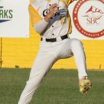 Shortstop, Ryan Ham, fielding a ground ball and preparing to throw out a base runner.