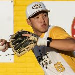 Shortstop, Ryan Ham, gripping the ball and preparing to throw to a base.