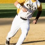 Base runner, Colby Rafail, rounds third base and heads for home.