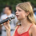 Singer, Bella, performs the National Anthem during the pregame ceremony.