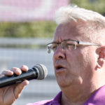 Scott Lewis sings the National Anthem at the pre-game ceremony.