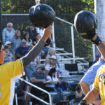Ariv Camacho and Bryce Tweedt tap helmets at home plate after a homerun by Tweedt.