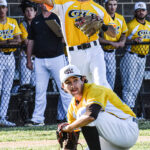 Third baseman Wyatt Larranaga throwing to first base with pitcher Gabriel Rojas ducking out of the way, May 29th, 2022