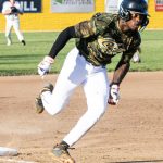 Colt 45s player Damico "DJ" Parker (8) rounding third base and heading for home.