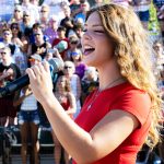 Guest singer performing the National Anthem during the pregame ceremony.