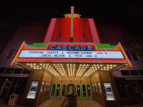 Frontal view of the Cascade Theatre building during the nighttime.